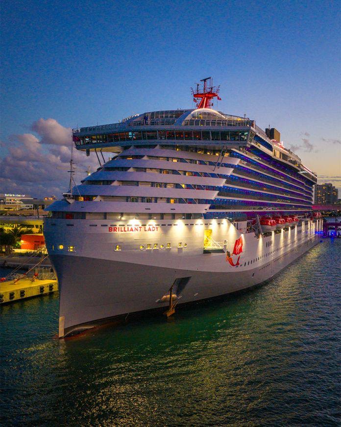 Virgin Voyages Brilliant Lady docked at sunset